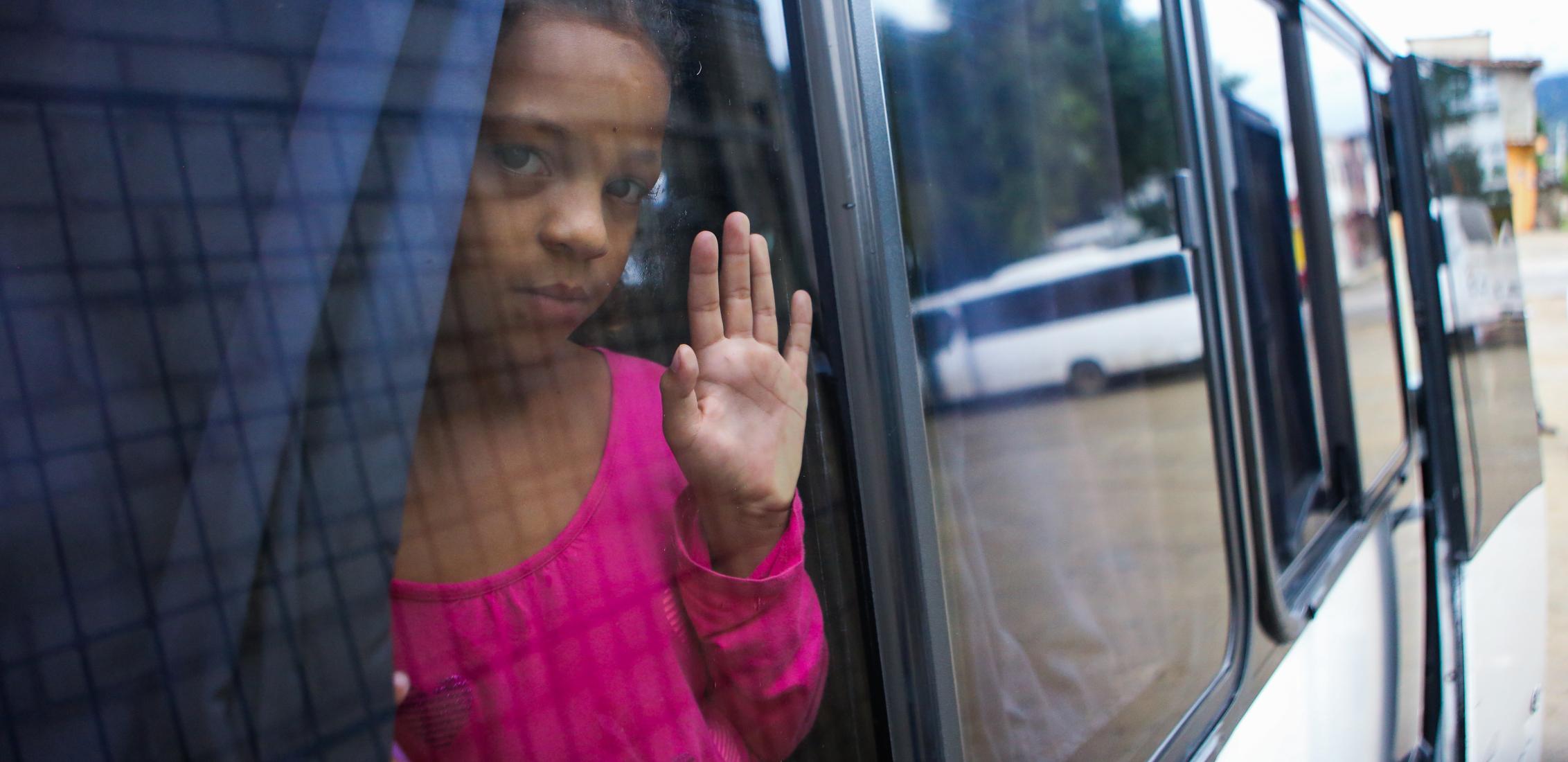 UNI480116/Membreño Edguimar, age 10, looks out of the window of the bus that will transport her to Tegucigalpa to follow the migration route to the United States, after leaving the Temporary Rest Center "Alivio del Sufrimiento" located in El Paraíso, on 4 November, 2023 in Honduras.
