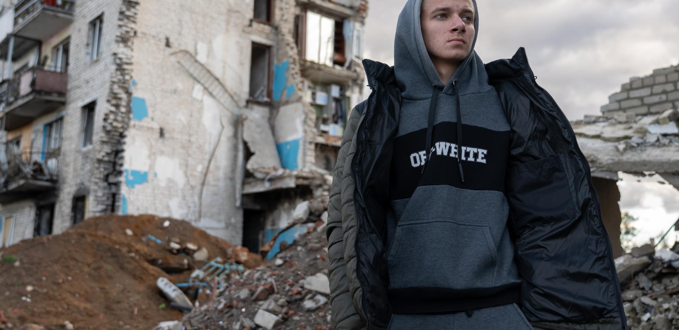 UNI484041/Filippov 17-year-old Habriel is standing in front of a building, destroyed by the shelling on 28 October 2023 in  Izium, Ukraine.